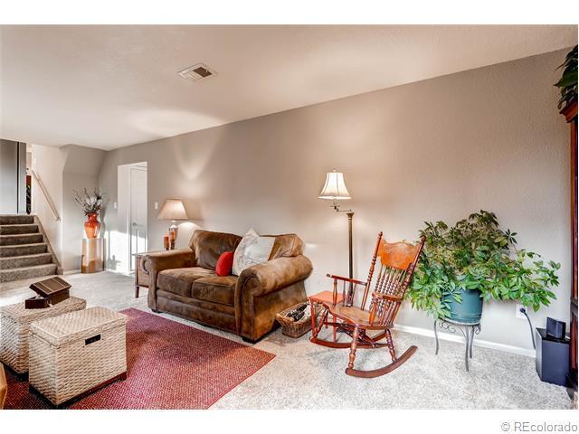 living room space with programmable thermostat controls for evaporative cooler and a separate one for gas forced air heating - 7091 Beech Street