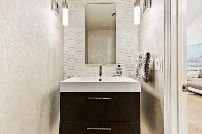 Gorgeous half bath powder room with floating vanity - 2535 NW 41st St