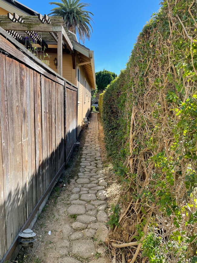 Triplex pathway that leads to mailboxes and 3rd Street. - 1749 E 3rd St