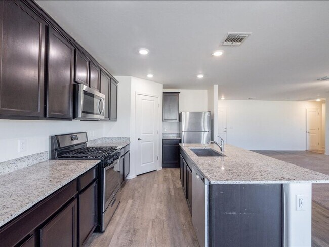 Building Photo - Spacious 4-Bedroom Home with Open Layout & Turf Backyard