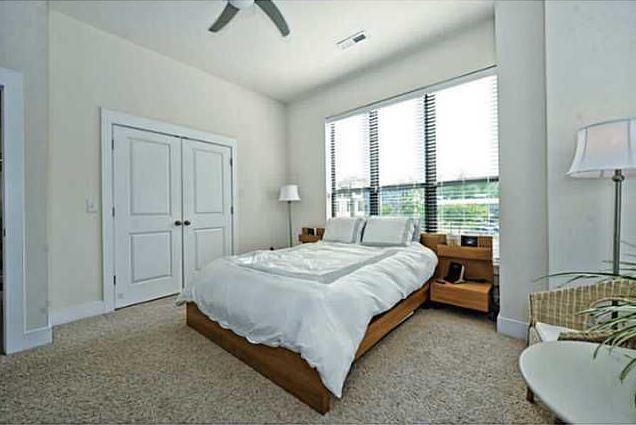 Master Bedroom featuring two walls of floor to ceiling windows and double-door closet. - 3433 Steel Yard Court