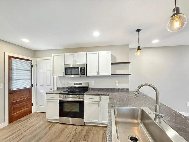Beautiful countertops with large sink and electric stove - 2610 63rd St