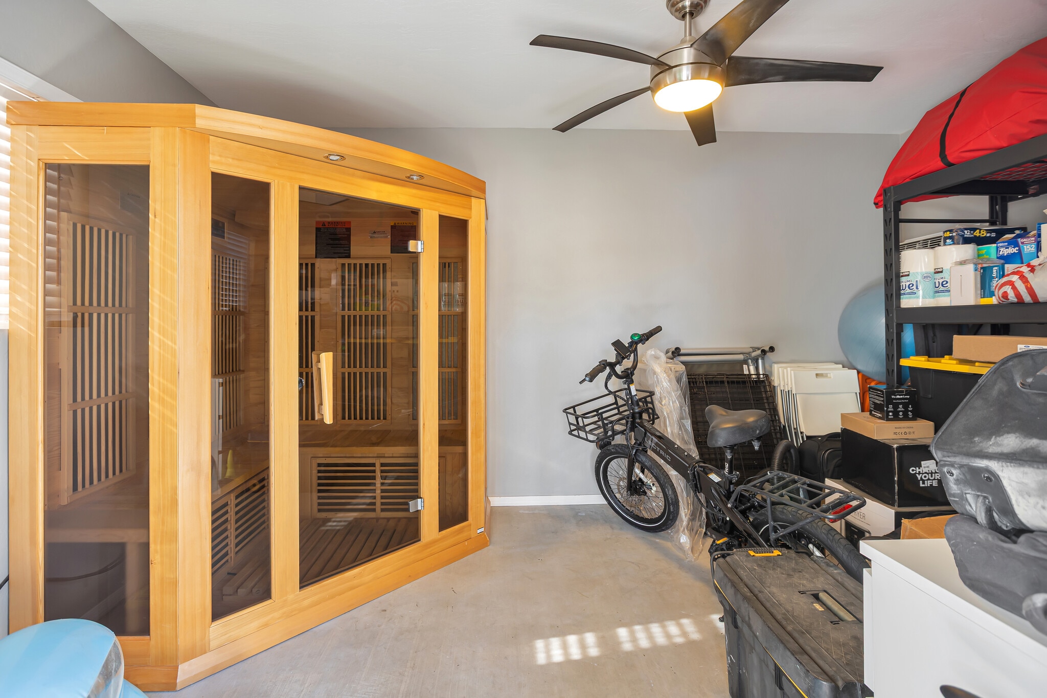 Modern shed with three-person infrared sauna, AC, ceiling fan, concrete flooring, and ample storage - 6136 N 9th St