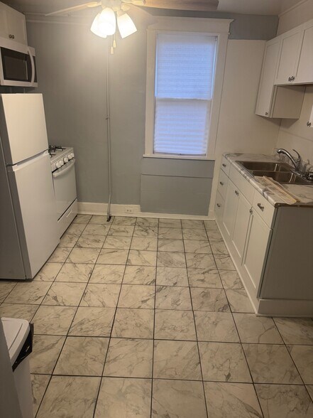 Kitchen w/ brand new stove, refrigerator, and microwave - 304 Arthur Ave