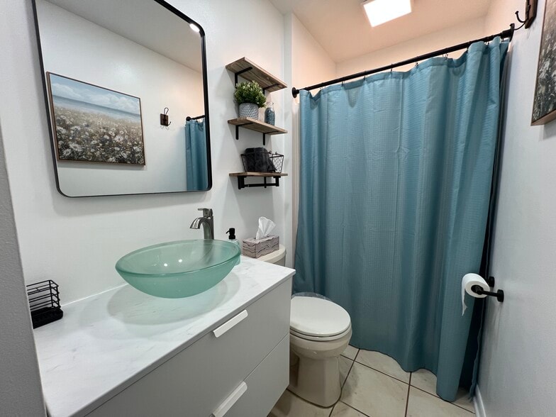 Clean bathroom with storage. Scale and hairdryer are available for use. - 908 Lake Rd