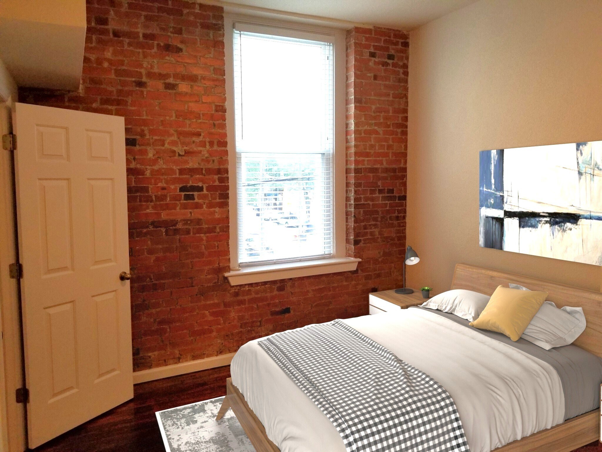Exposed brick and large window in bedroom. - 304 N Front St