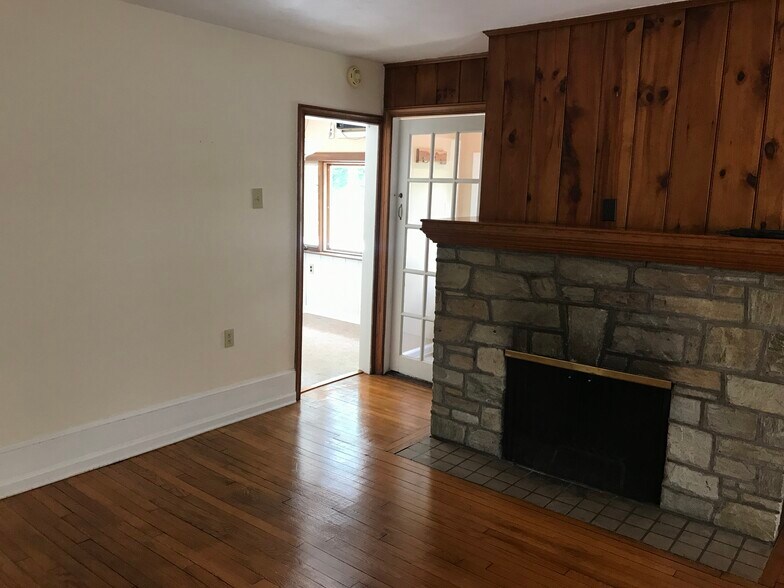 Den off the kitchen and entrance. Non-burning fireplace. - 106 Morgan Ave