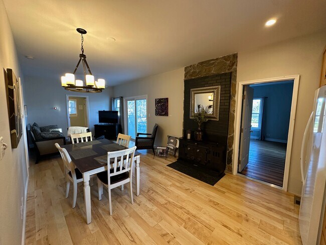 Dining and living area with ornamental original wood burning stove - 4804 Friends School Rd