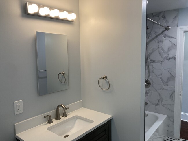 Entering the brand new full bathroom, you're welcomed with lovely tile, handsome fixtures and tons o - 2621 E Somerset St