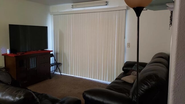 Living room with Sunscreens - 5710 E Tropicana Ave