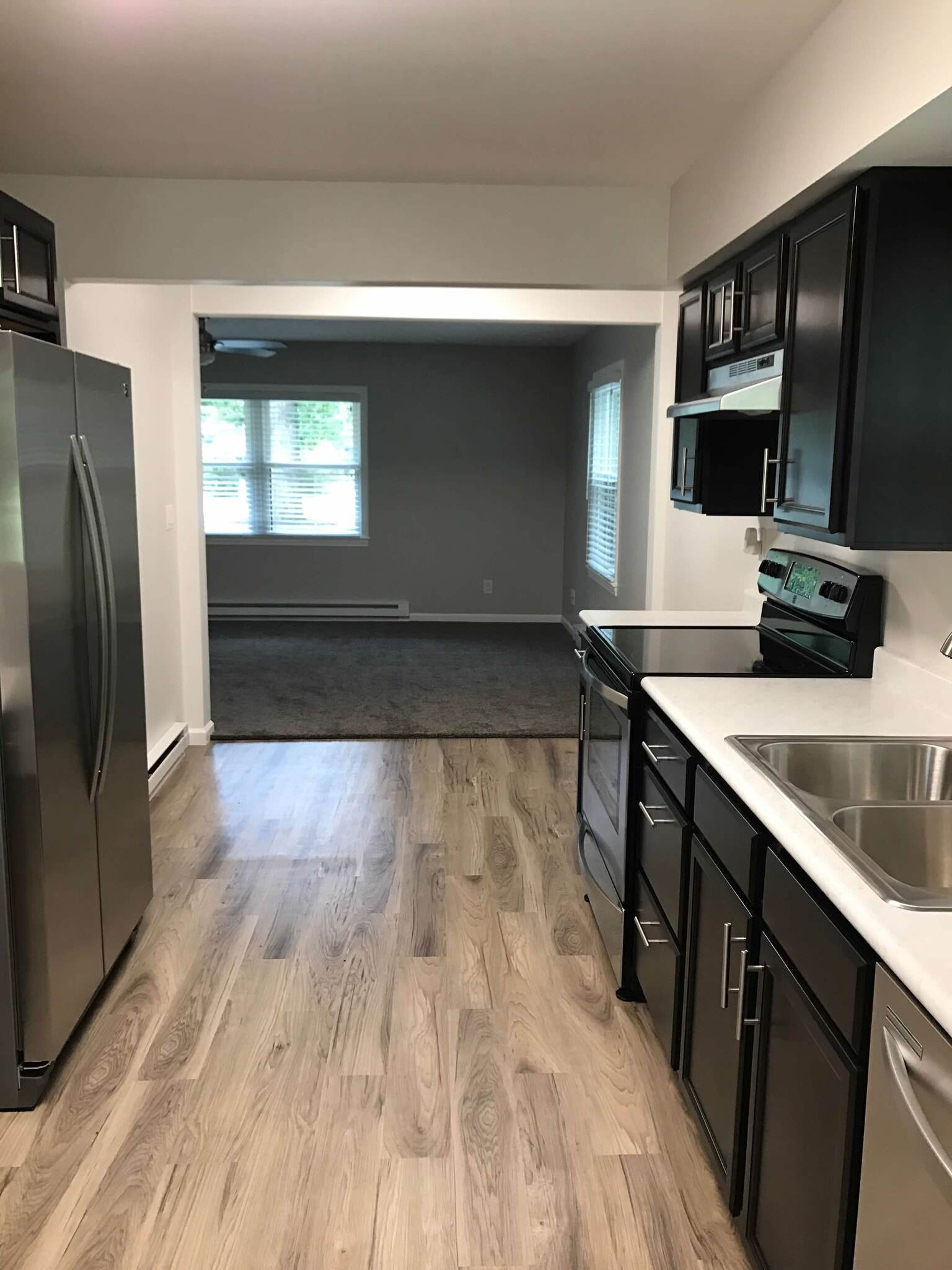 Espresso cabinets with marbled-look white countertops. - 874 A Pleasant Ridge Rd