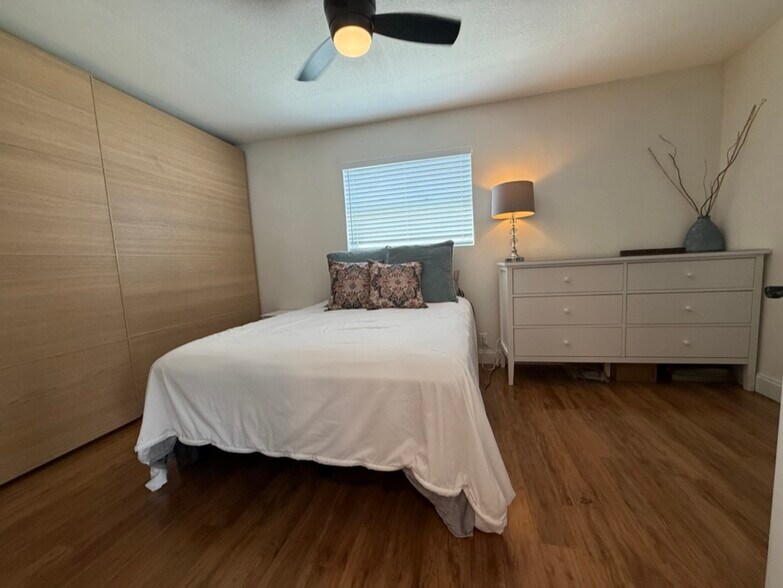 This is the primary bedroom. The oak doors slide open to reveal closet storage with shelves/drawers - 129 36th Ave NE