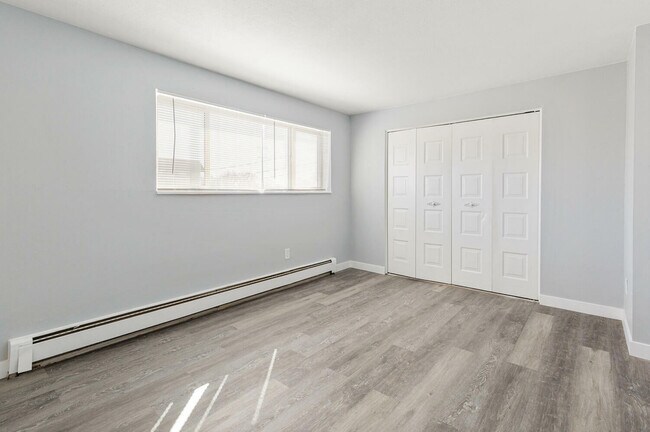 Enjoy natural light in this elegant bedroom, featuring modern design elements. - Country Club