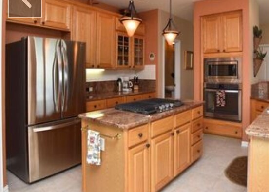 Open kitchen with breakfast bar, gas stove and stainless steel appliances. - 429 Beaver Point