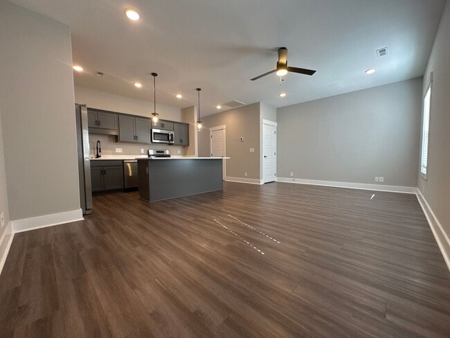 Building Photo - “Stylish 3BR End-Unit | Open Concept | Quartz Kitchen | Garage + Deck