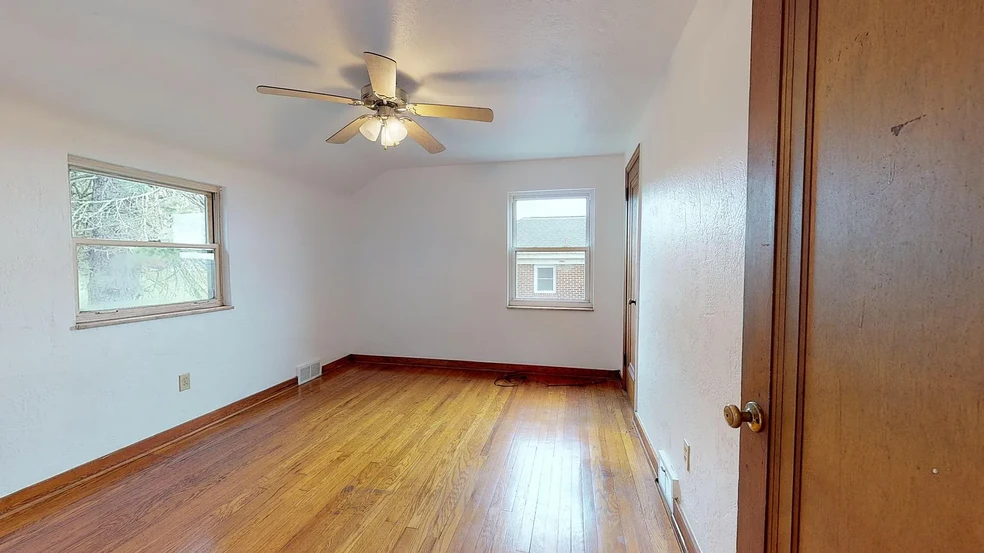 Spacious Bedroom #2 with refinished original hardwood flooring - 31 Marylea Ave