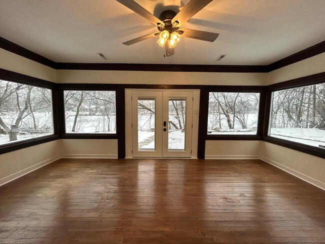 Living room with large picture windows looking to the river - 11761 N River Rd