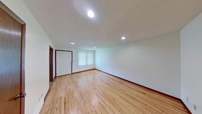 Building Photo - Updated two bedroom duplex, new stainless steel appliances, garage, and hardwood floors