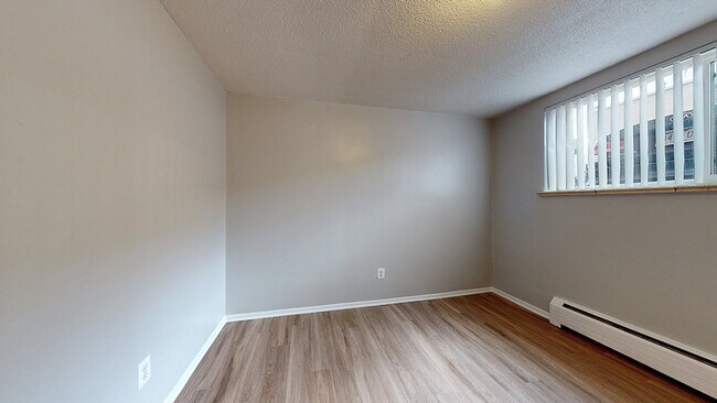 Embrace the simplicity in this bright and airy bedroom. - Harmony Apartments