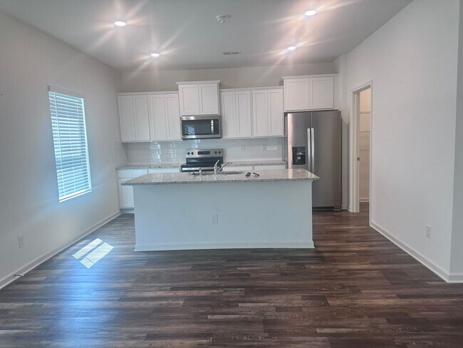Building Photo - efficient two-level home provides a large living room, 4 very spacious bedrooms, and 2.5 bathrooms