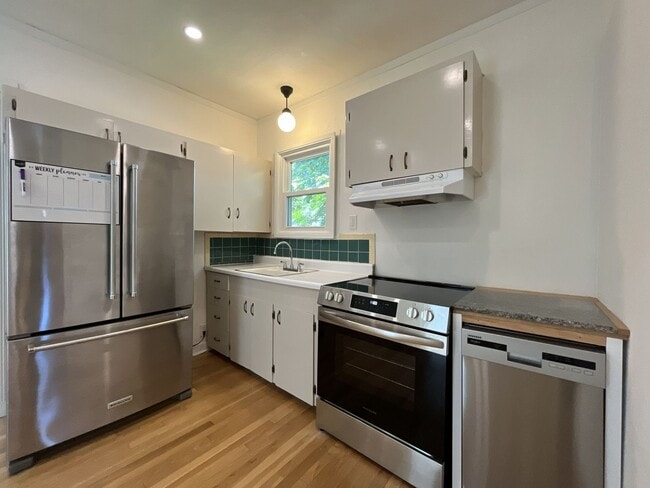 Building Photo - Charming Cottage with Hardwood Flooring, Modern Kitchen & Beautiful Outdoor Living Areas