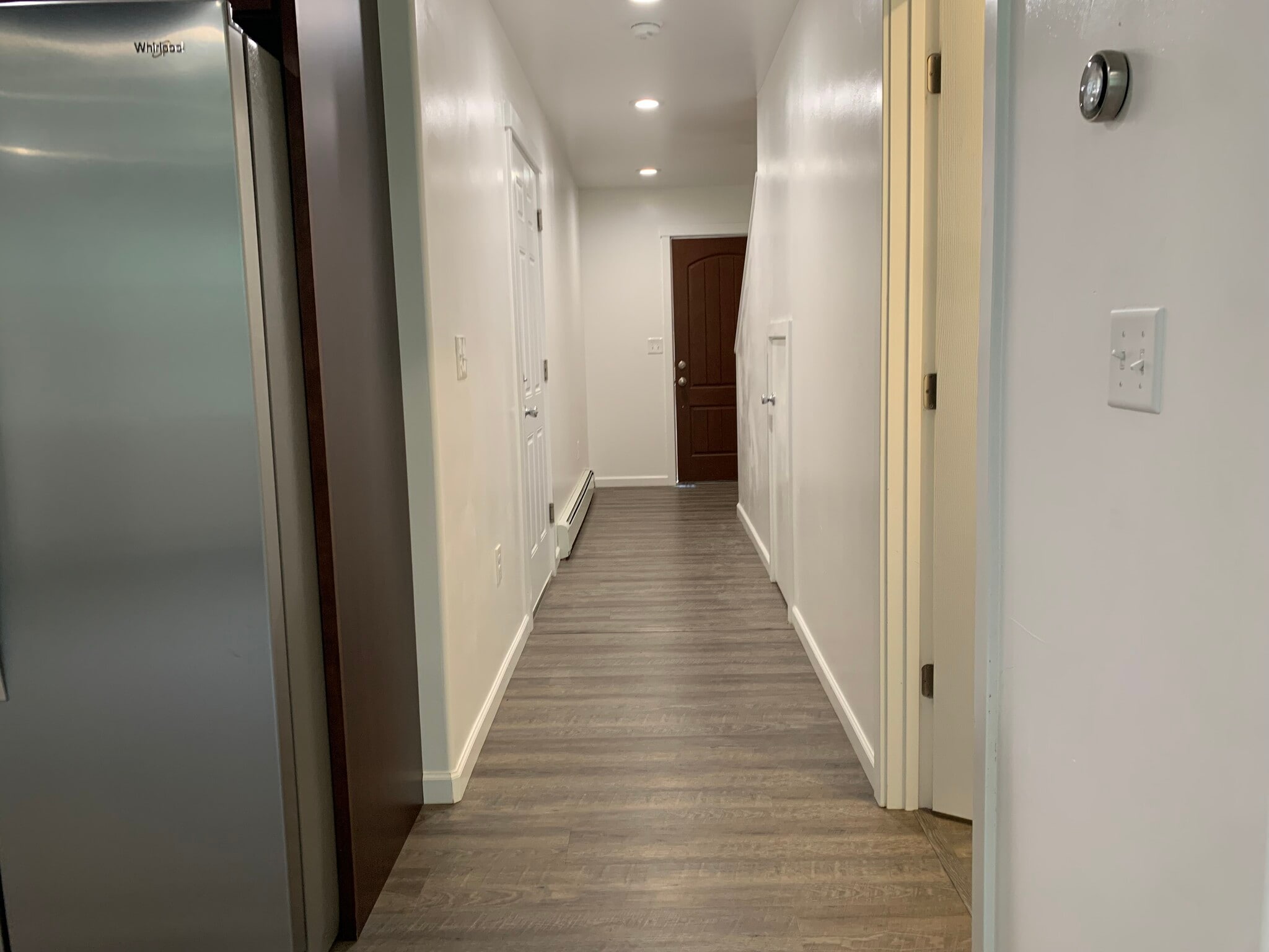Down stairs hall, leading to front door as you pass the half bath and garage door. - 1515 S Clearwater Ave