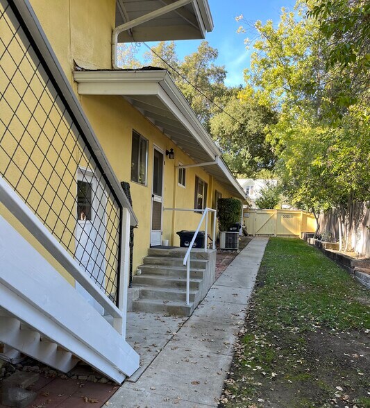 Back Door to backyard with steps to secured garage area. Security lighting at night - 513 28th St