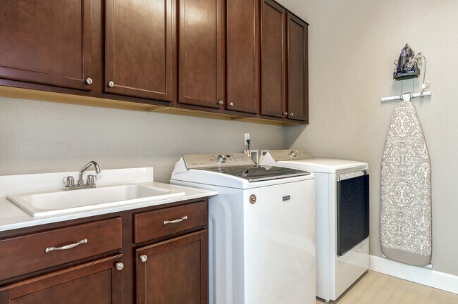 Laundry room, full sized washer, dryer, and utility sink. - 1410 Promontory Bluff Vw