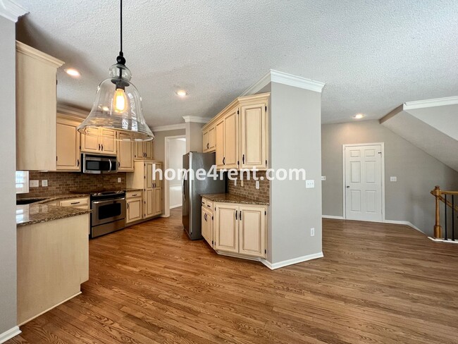 Building Photo - Updated Kitchen, Large Two Tiered Deck, Finished Basement in Blue Valley Schools!
