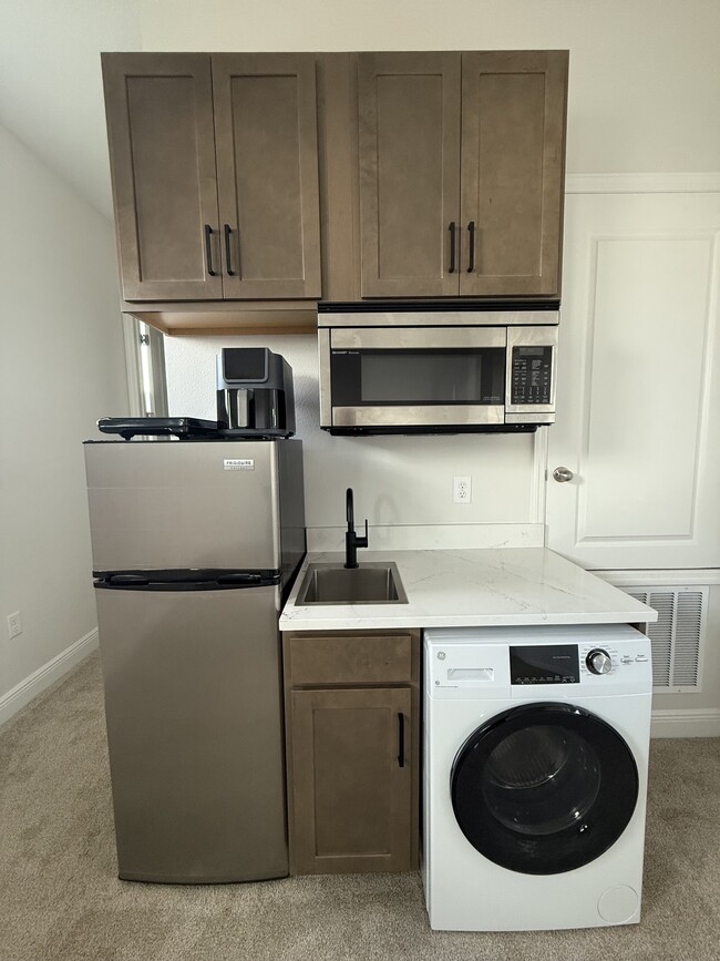 Kitchenette includes air fryer and double burner cooktop (pictured above fridge). - 3109 Voyager Ave