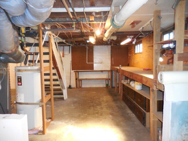 Unfinished basement with work bench - 4626 N Mullen St