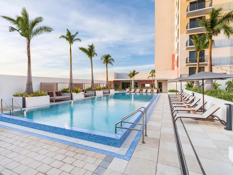 Relax in style with our resort-style pool, cabanas, and lounge seating. - Modera St. Petersburg