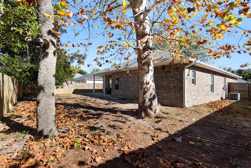 Backyard has a private fence, patio furniture, and barbecue - 28 Snook Rd