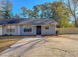 Building Photo - LOVELY & Modern NW 2/1 w/ New Flooring & Huge Privacy Fenced Yard that Inc Lawn Maintenance! Avai...