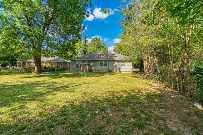 Building Photo - Three Bedroom Home in tree filled neighborhood! Lawn care included!
