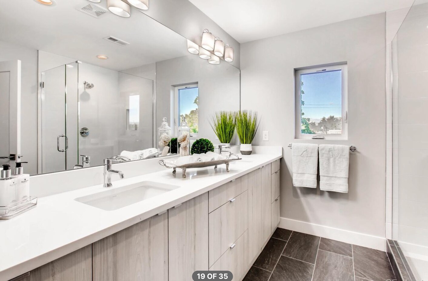 bath in second bedroom suite has dual vanities and a large , walk-in shower - 2765 S Sherman St