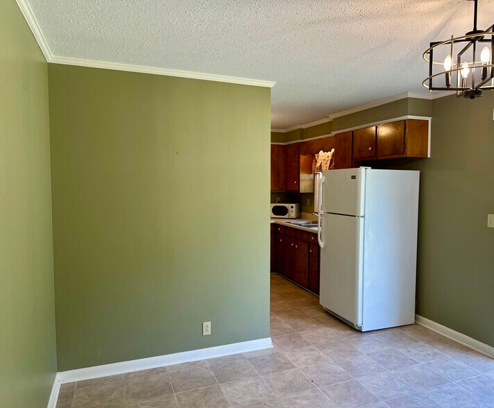 Dining Room looking into the kitchen (from the backdoor entrance from carport). - 9 Garden Ln