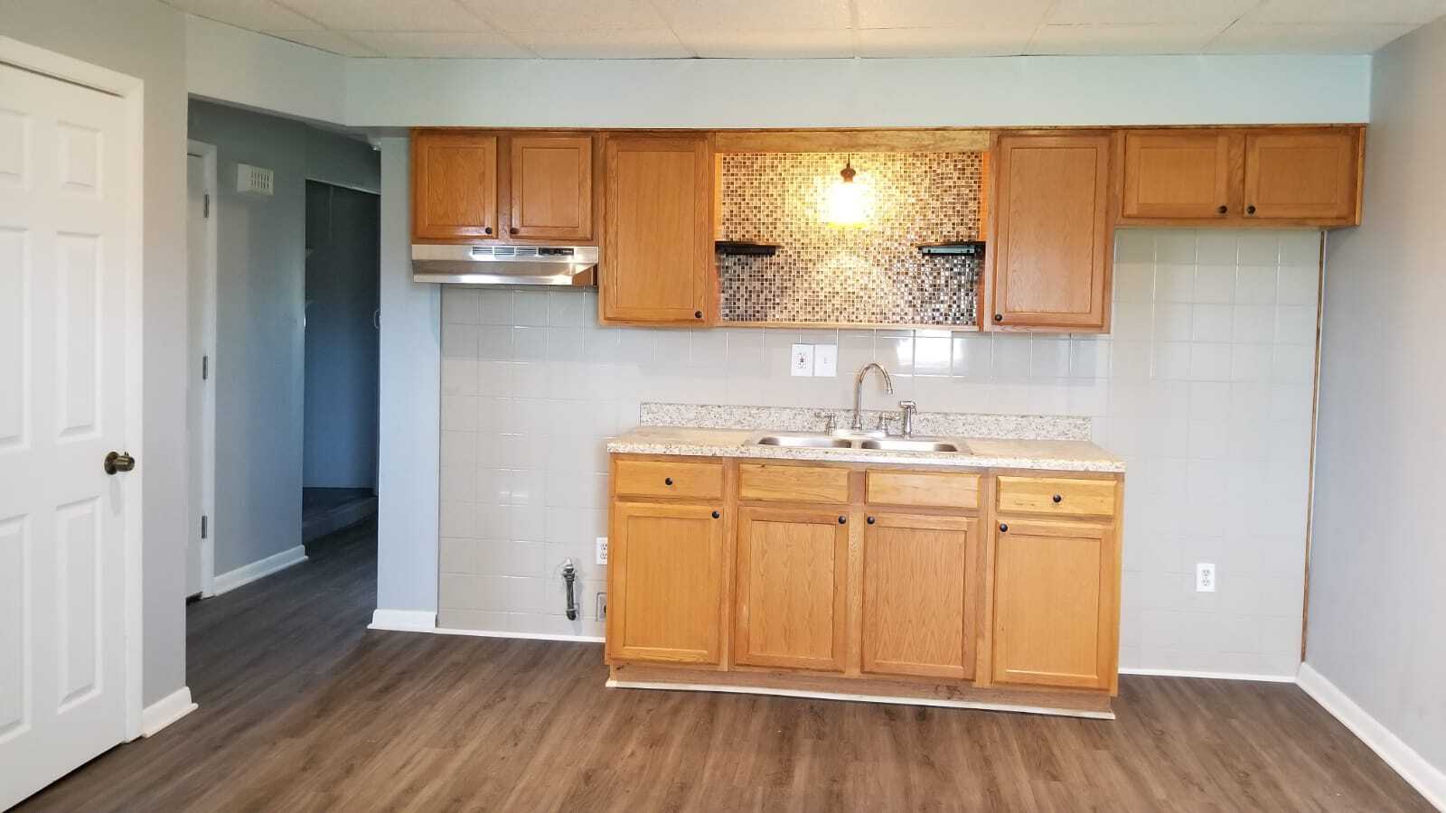 Click on picture to open full scale. Kitchen cabinets. Gas or electric stove hookup. Range hood. - 424 Waddell Ave