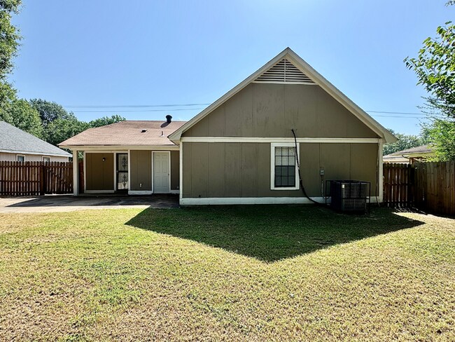 Building Photo - Charming 3BR/2BA Near Southwind | Soaring Vaulted Ceilings, Brick Fireplace & Fenced Yard