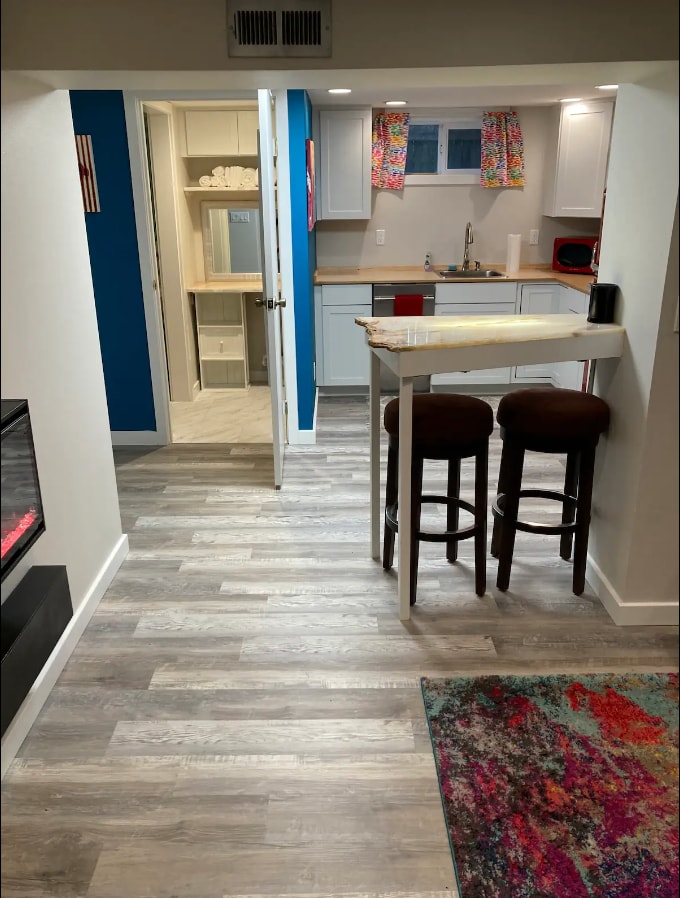 Bar separating living room and kitchen. Open door leads to full bathroom. - 4115 SE Gladstone St