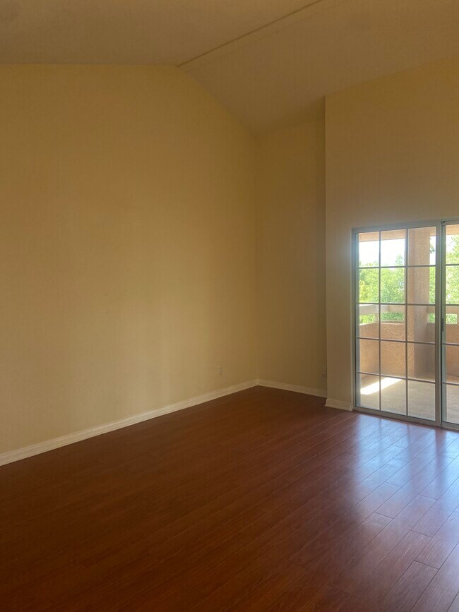 Master bedroom with vaulted ceilings, walk-in closet, renovated bathroom and balcony. - 435 E Valencia Ave