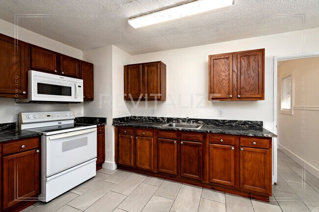 Building Photo - 3 BR 2 BA Home with Fenced Yard & Carport