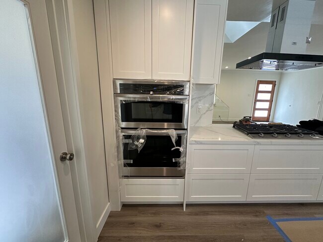 Built in microwave and oven next to stove. - 1241 Elmer St