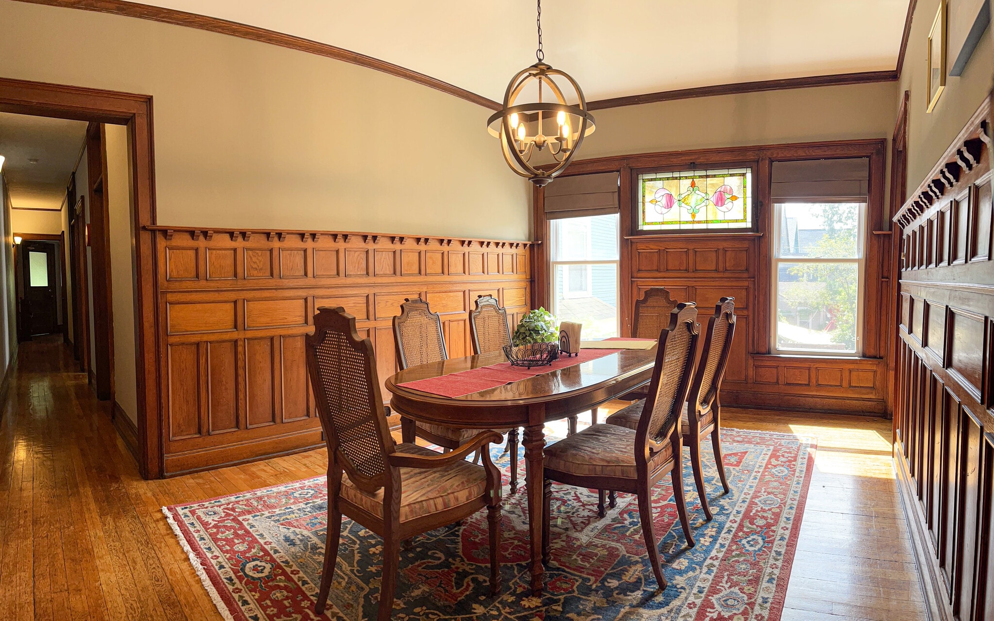 [Dining room] Features all-original wood paneling, and stained-glass window. - 103 Lancaster Ave