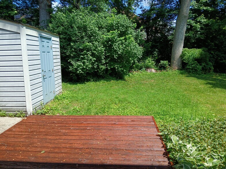Backyard, flower/vegetable garden, deck, and storage shed - 6026 Cedar Wood Dr