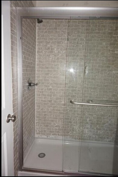 Large glass shower and tube for the master suite. - 2205 Chase Ct