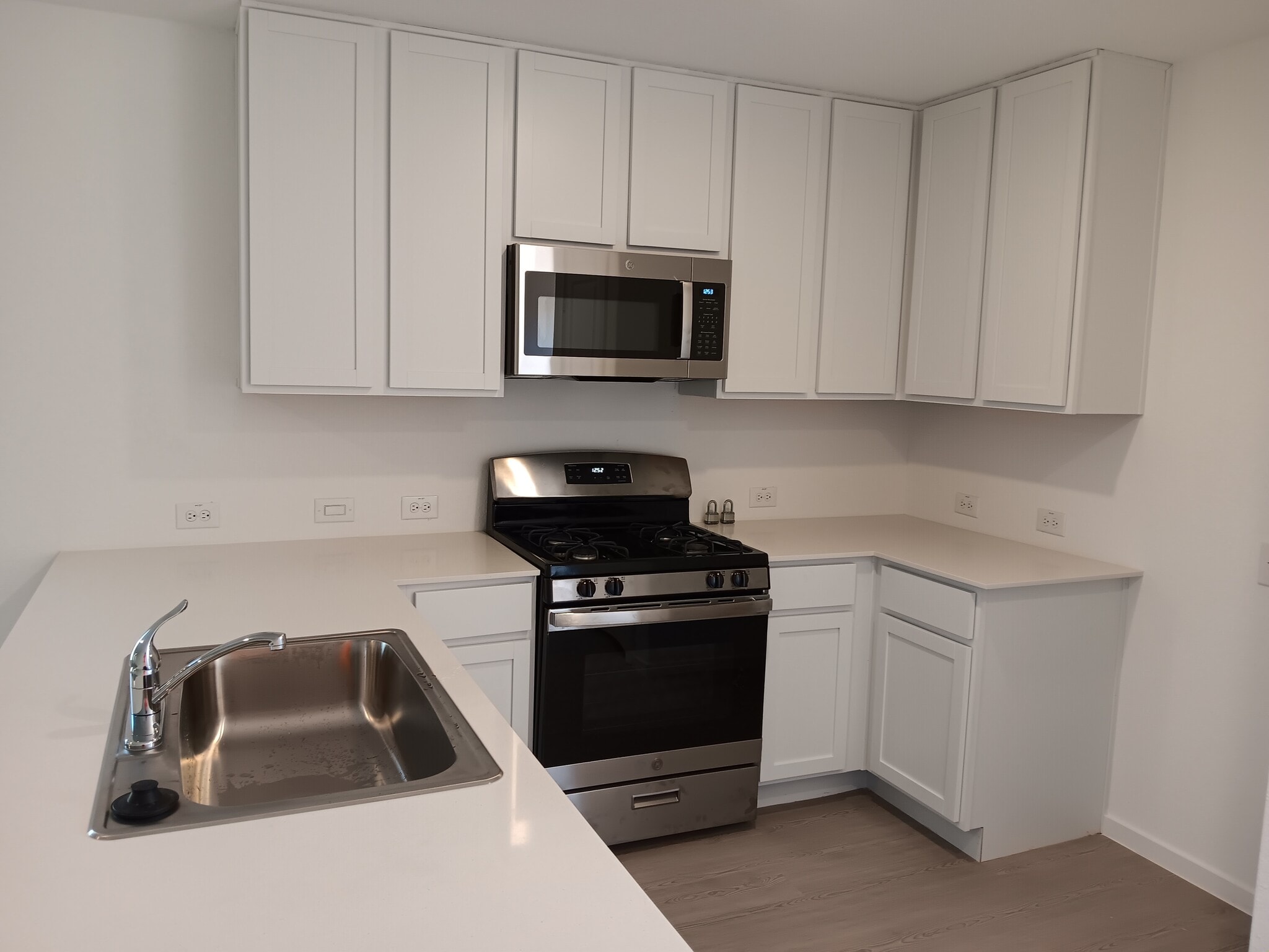 Kitchen with New Gas Stove and Microwave countertops - 20336 Red Coral