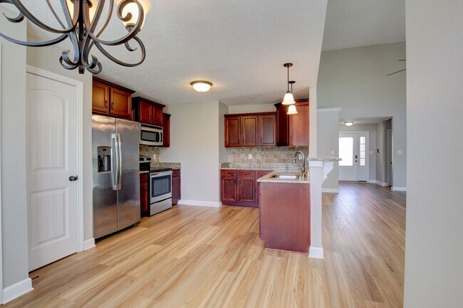 Building Photo - Fantastic Open Floor Plan Home With Stone Front Fireplace, Stainless Steel Appliances, And Close ...