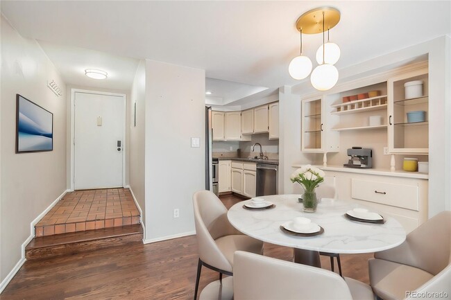 Dining area with modern lighting fixture and built in bar. - 701 Harlan St