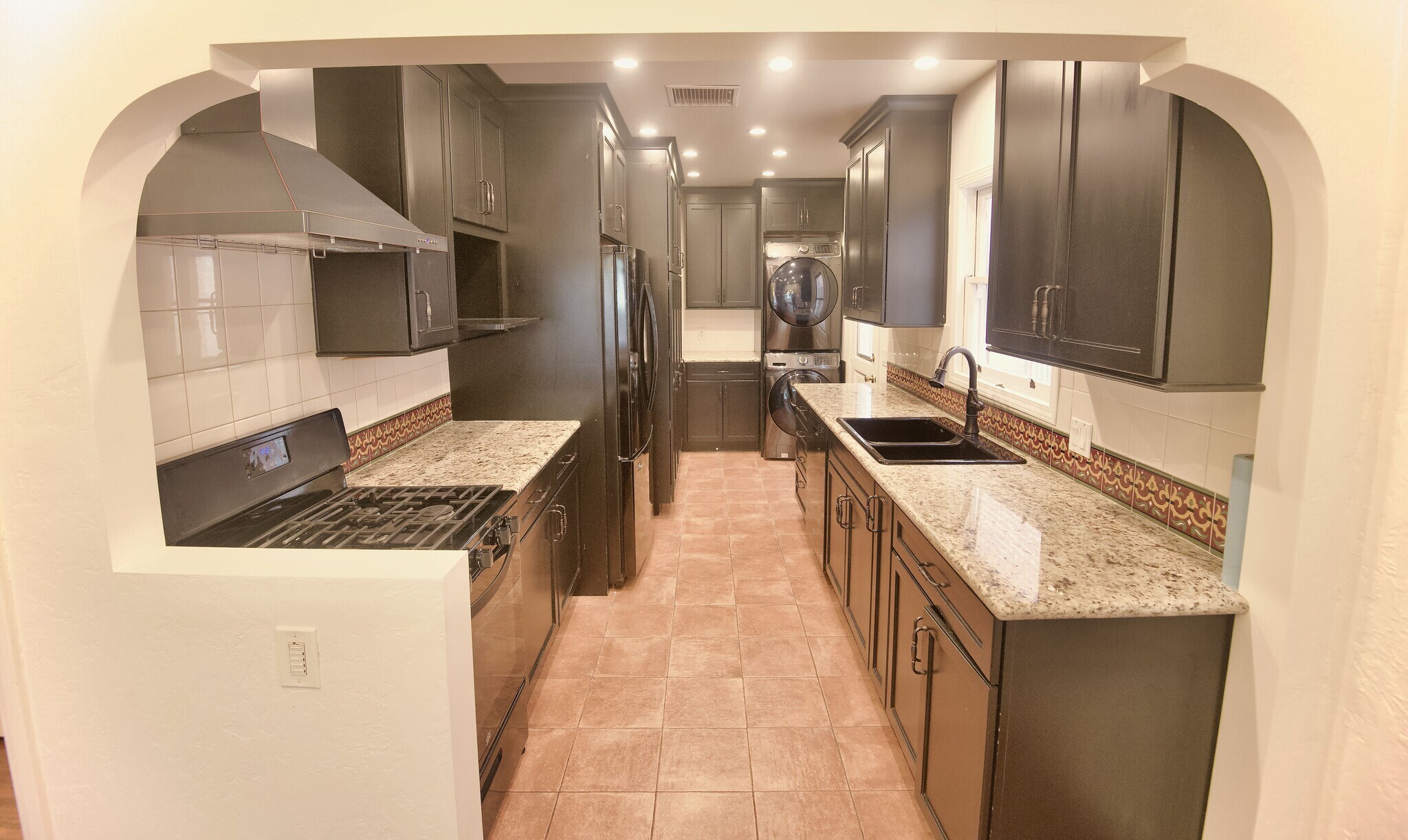 Kitchen with ample storage and stacked washer/dryer - 4755 Wiota St